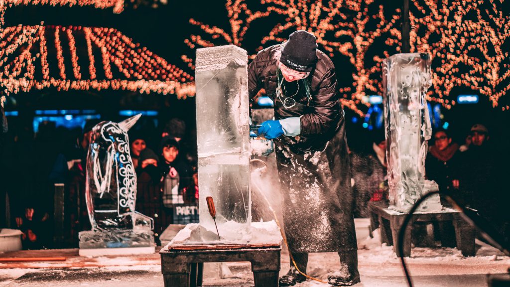 A person carving an ice sculpture.