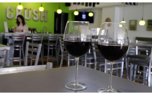 Two wine glasses on a table at crush wine bar.