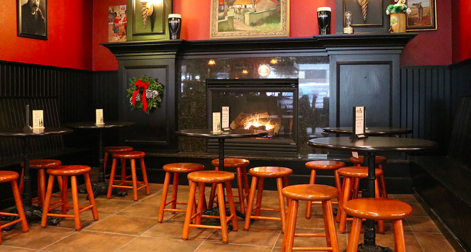 Tables by the fireplace at Five Points Irish Pub.