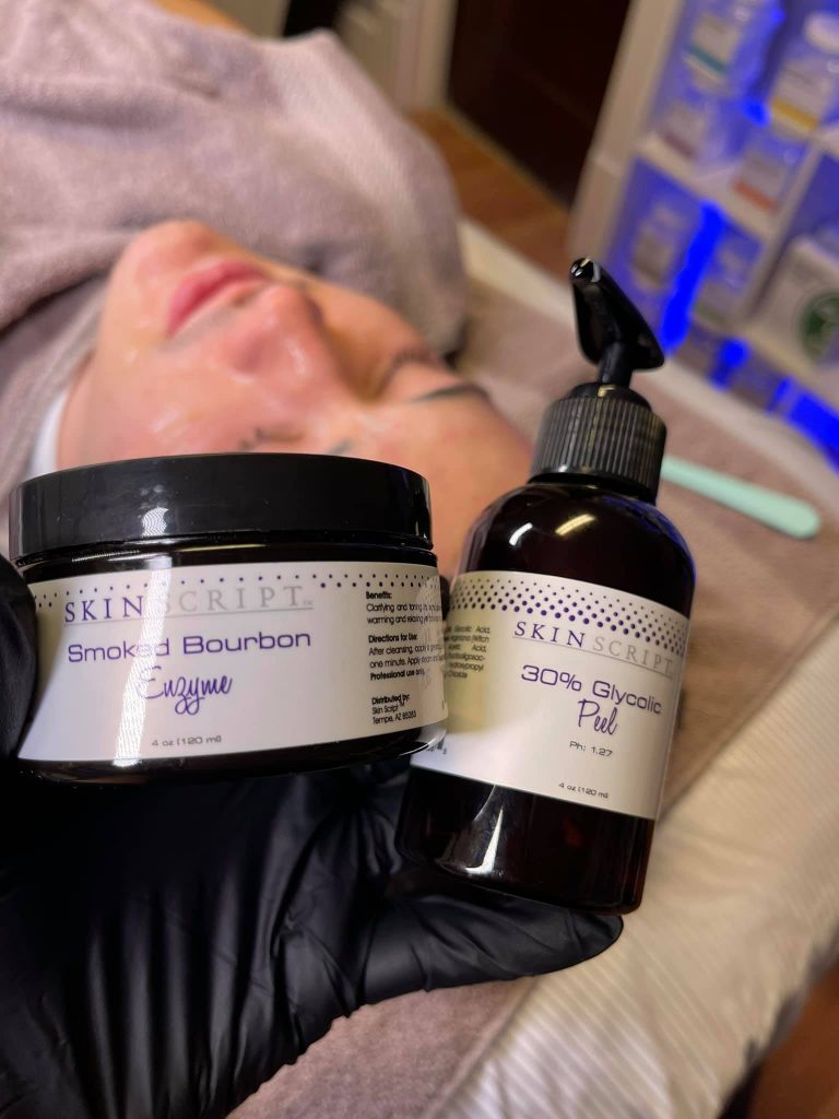 Facial products being held up in front a someone.