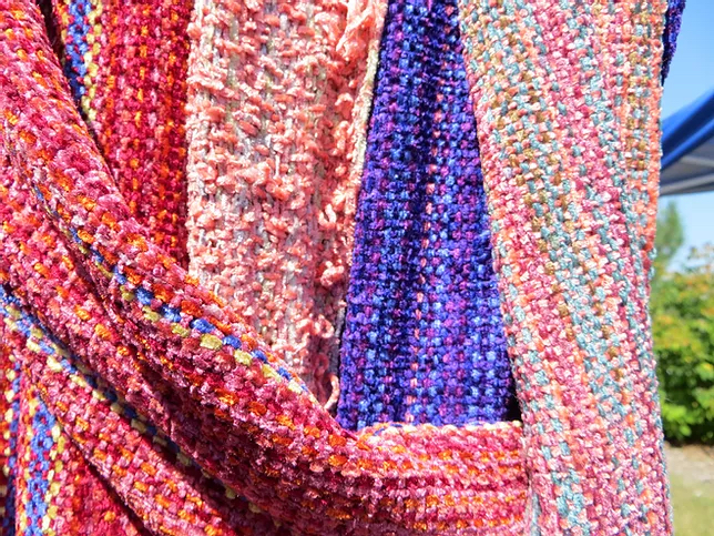 Red, pink and purple handwoven scarves.